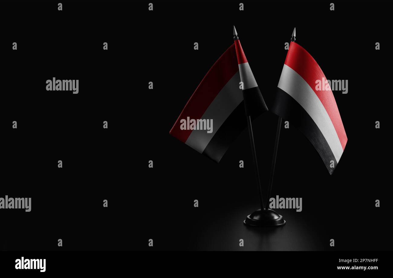 Small national flags of the Yemen on a black background. Stock Photo