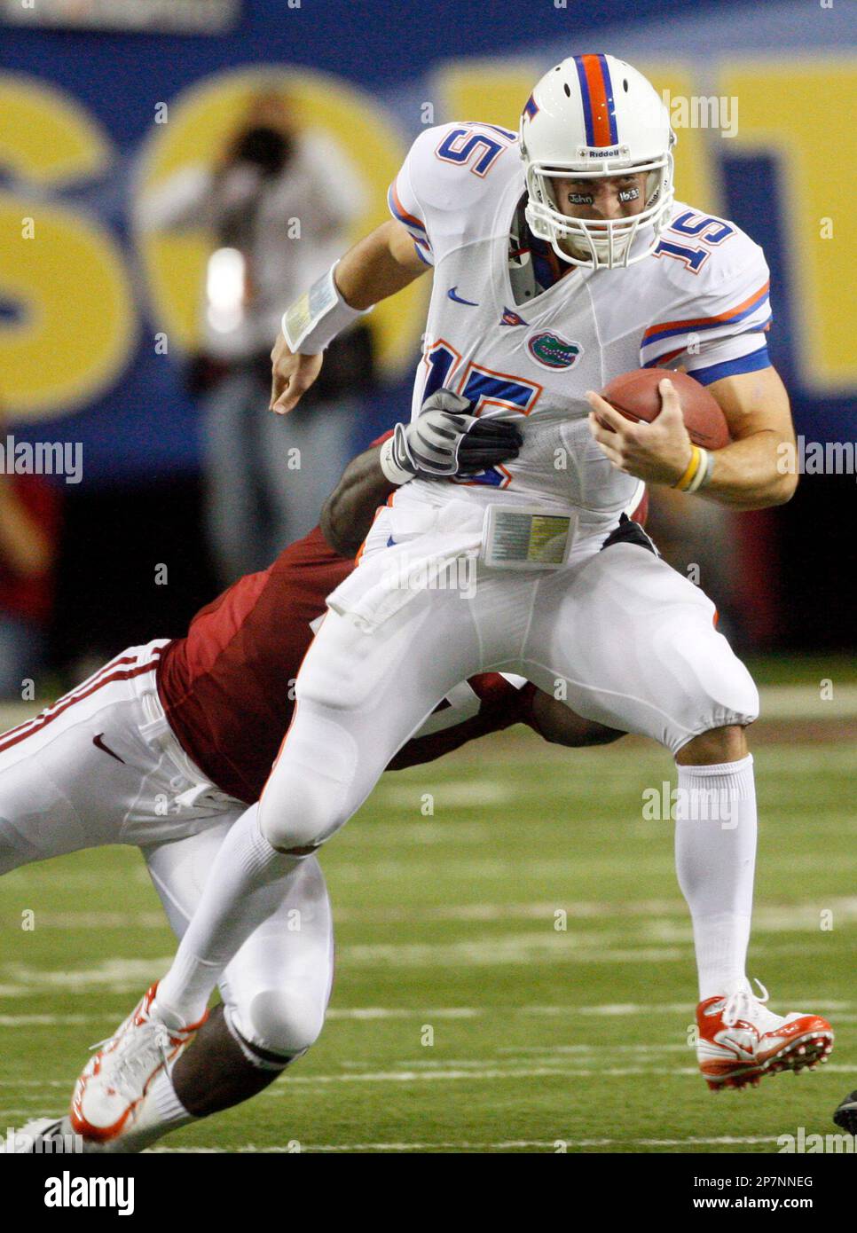 Florida quarterback Tim Tebow (15) is dragged down by Alabama's Rolando ...