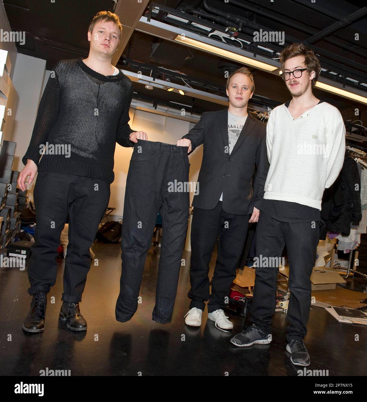 NoKo Jeans founders, from left to right, Jakob Ohlsson, Tor Rauden  Kallstigen and Jacob Astrom pose with a pair of their North Korean produced  jeans during the launch of their line of
