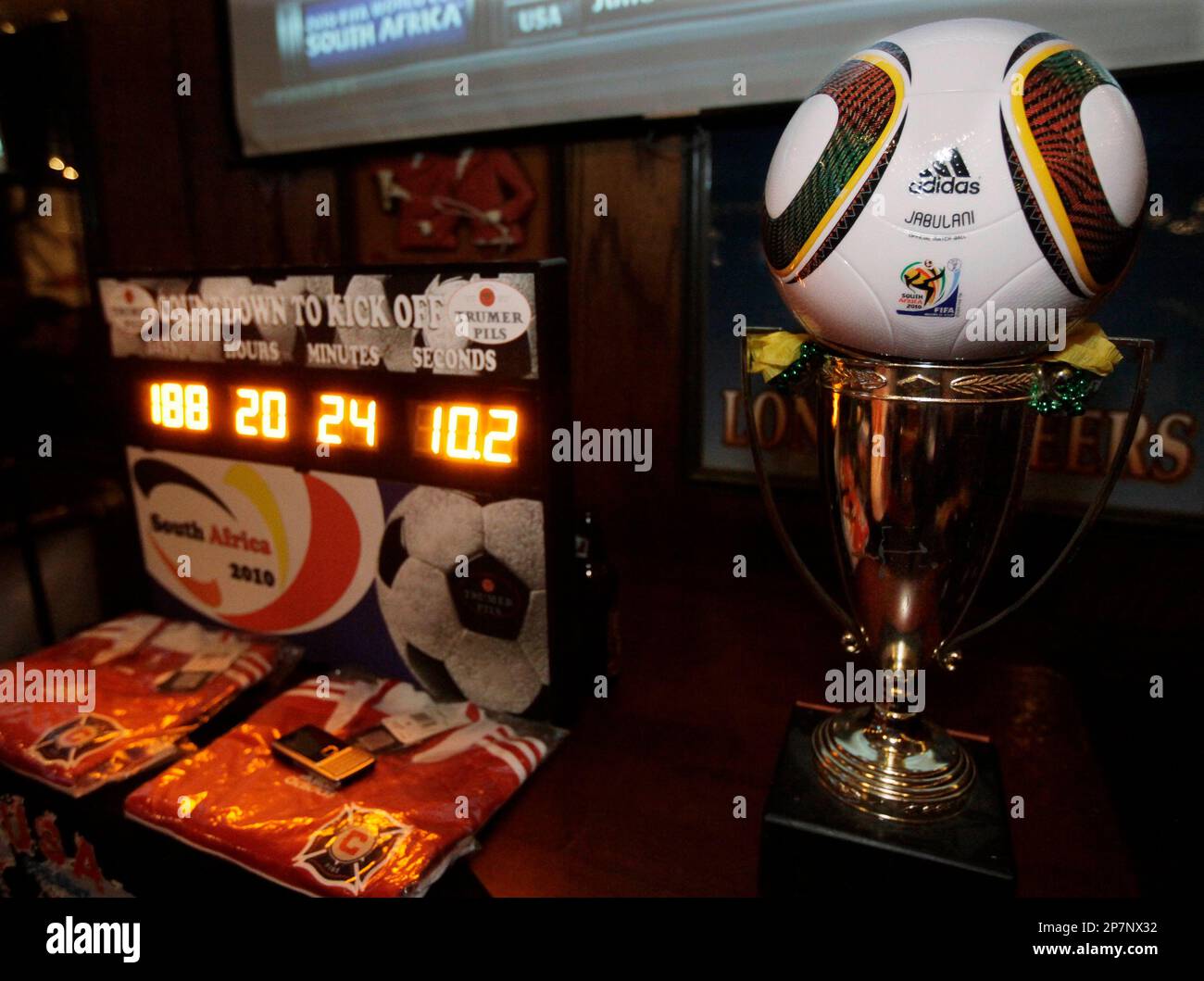 A countdown clock sits next to the official ball of the 2010 FIFA Would ...