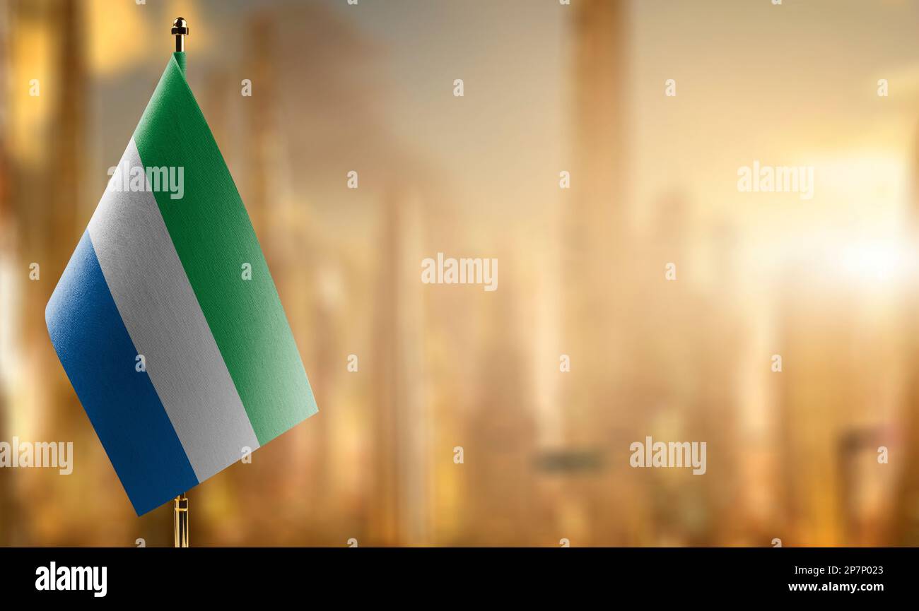Small flags of the Sierra Leone on an abstract blurry background Stock ...
