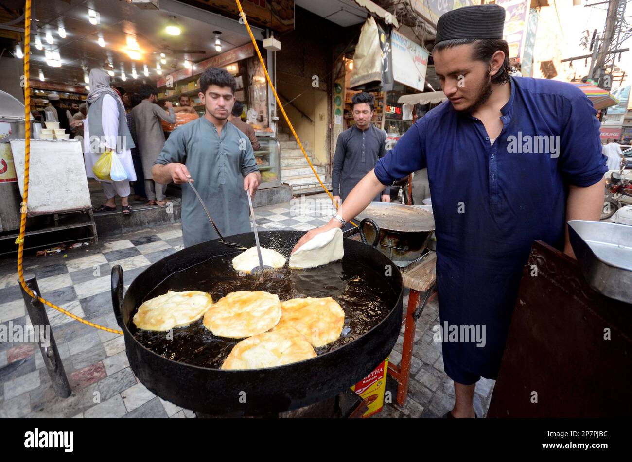 Peshawar, Pakistan. 07th Mar, 2023. Vendors at a stall in the Qissa