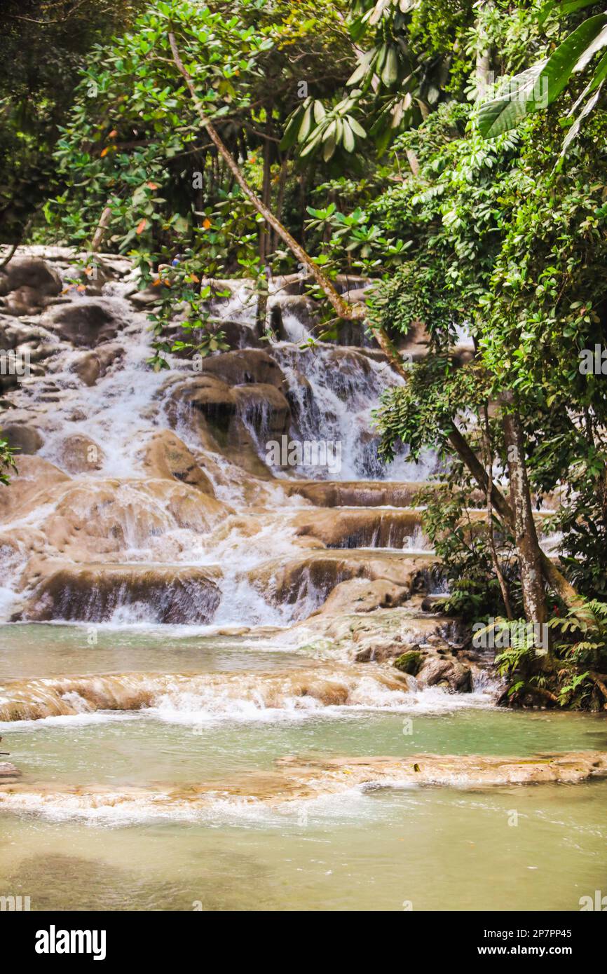 Water cascades over rocks at Dunn's River Falls in Ocho Rios, Jamaica Stock Photo