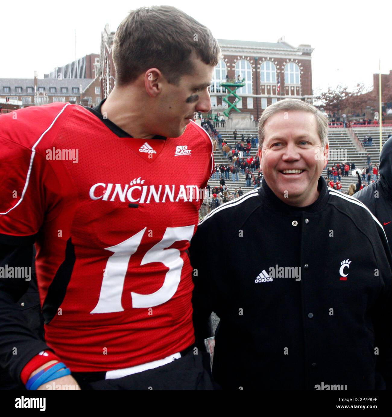 Cincinnati head coach Brian Kelly, right, walks with quarterback Tony