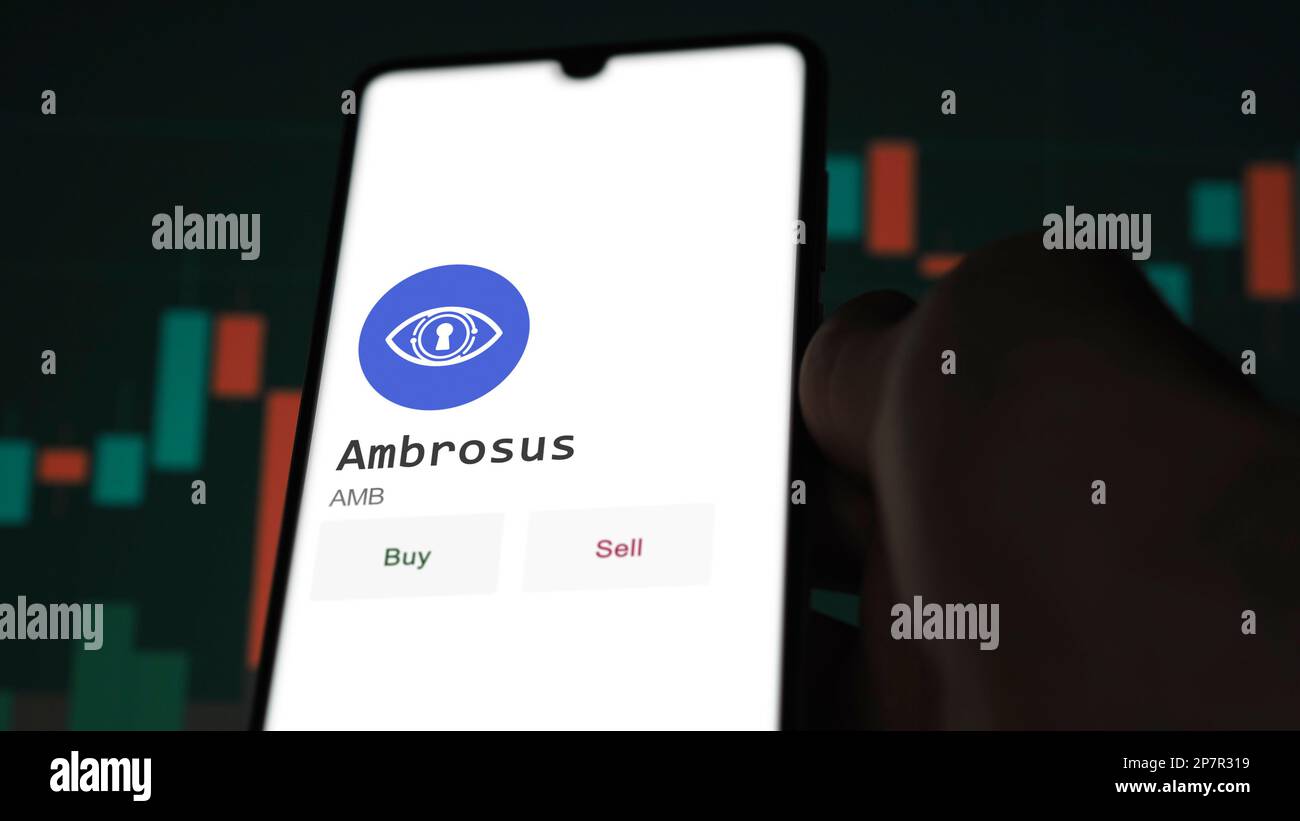 An investor's analyzing the Ambrosus ( AMB ) coin on screen. A phone shows the crypto's prices to invest in ambrosus token. Stock Photo