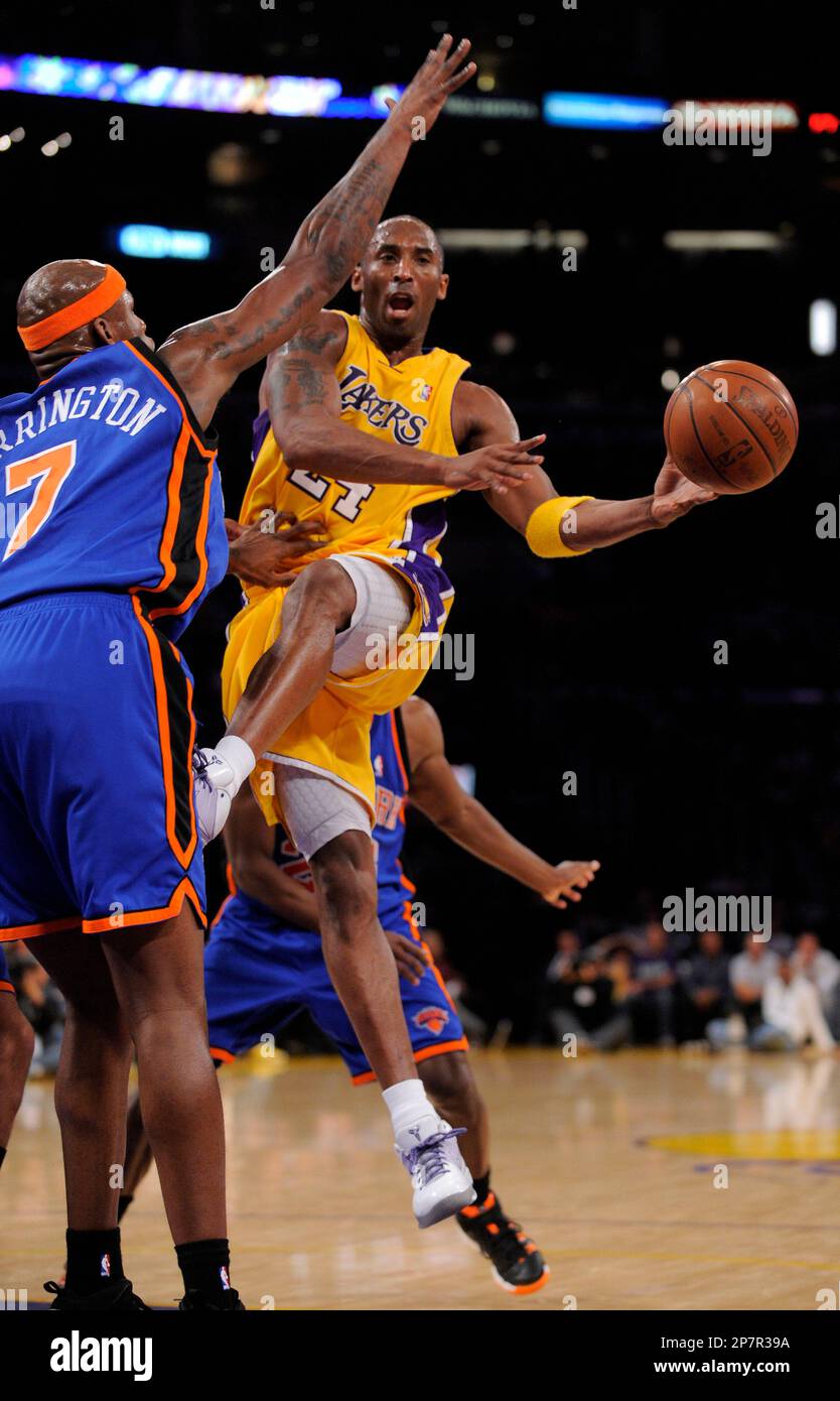 Los Angeles Lakers guard Kobe Bryant, right, passes around New
