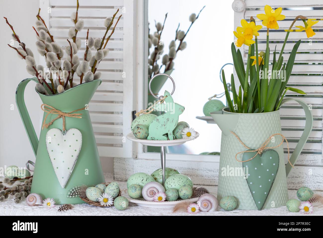 easter arrangement with easter bunny, eggs, narcissus and willow catkins in vintage jug Stock Photo