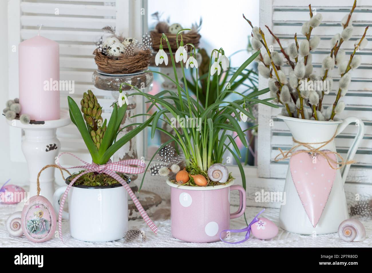 spring arrangement with snowdrops, hyacinth and willow catkins in vintage enamel pots Stock Photo
