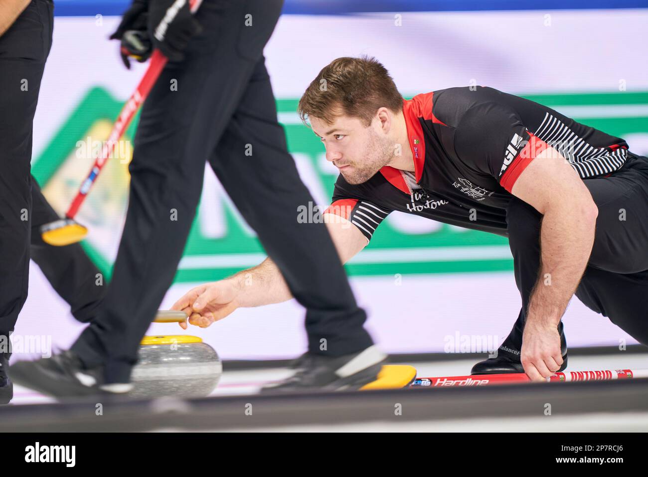 Ontario lead Joey Hart releases his shot during their match against New Brunswick at the Tim Hortons Brier curling event Wednesday, March 8, 2023, in London, Ontario