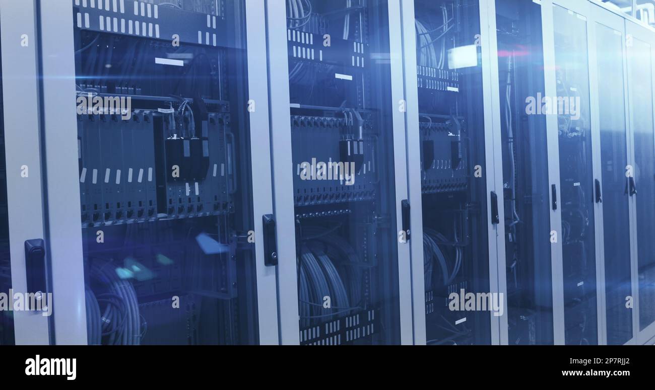 Composition of glowing light and data processing over computer servers Stock Photo