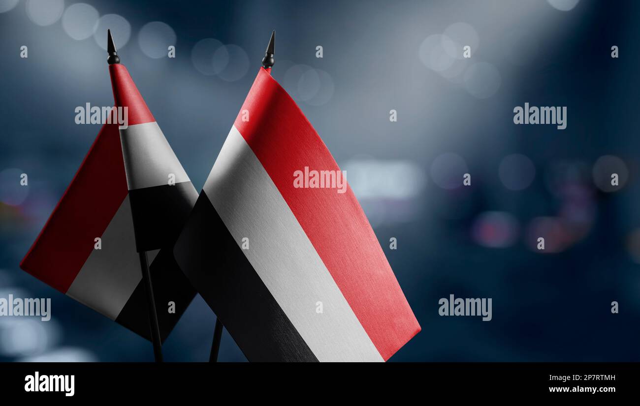 Small flags of the Yemen on an abstract blurry background Stock Photo