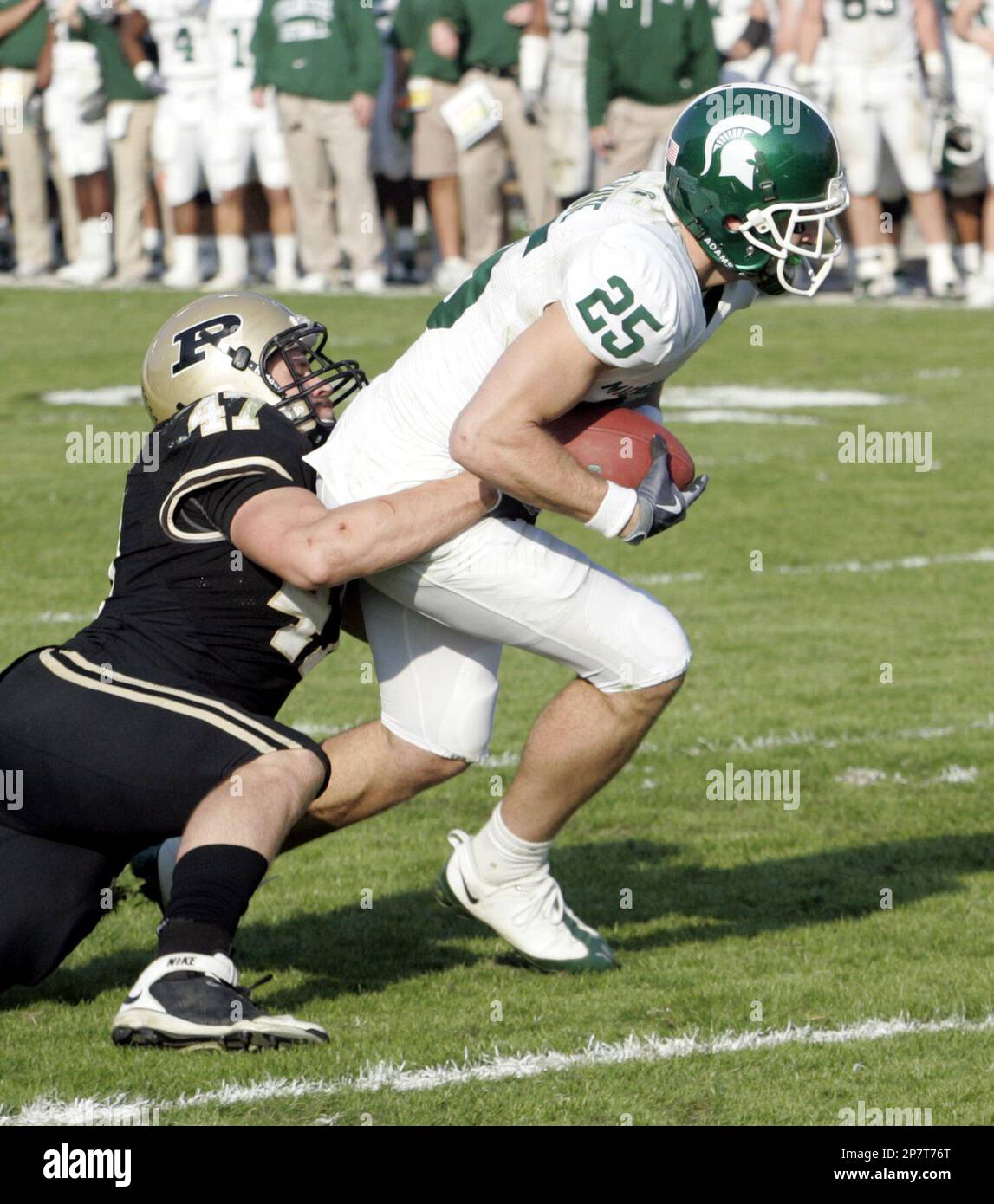 Michigan State wide receiver Blair White (25) drags Purdue linebacker Chris  Carlino (47) across the goal line as he scores on a 9-yard pass play in the  fourth quarter of an NCAA