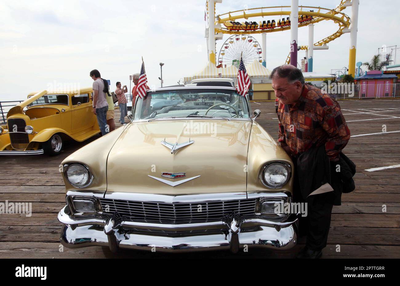 Sorin Gholian looks over a 1956 Chevolet, part of a 66 car caravan as