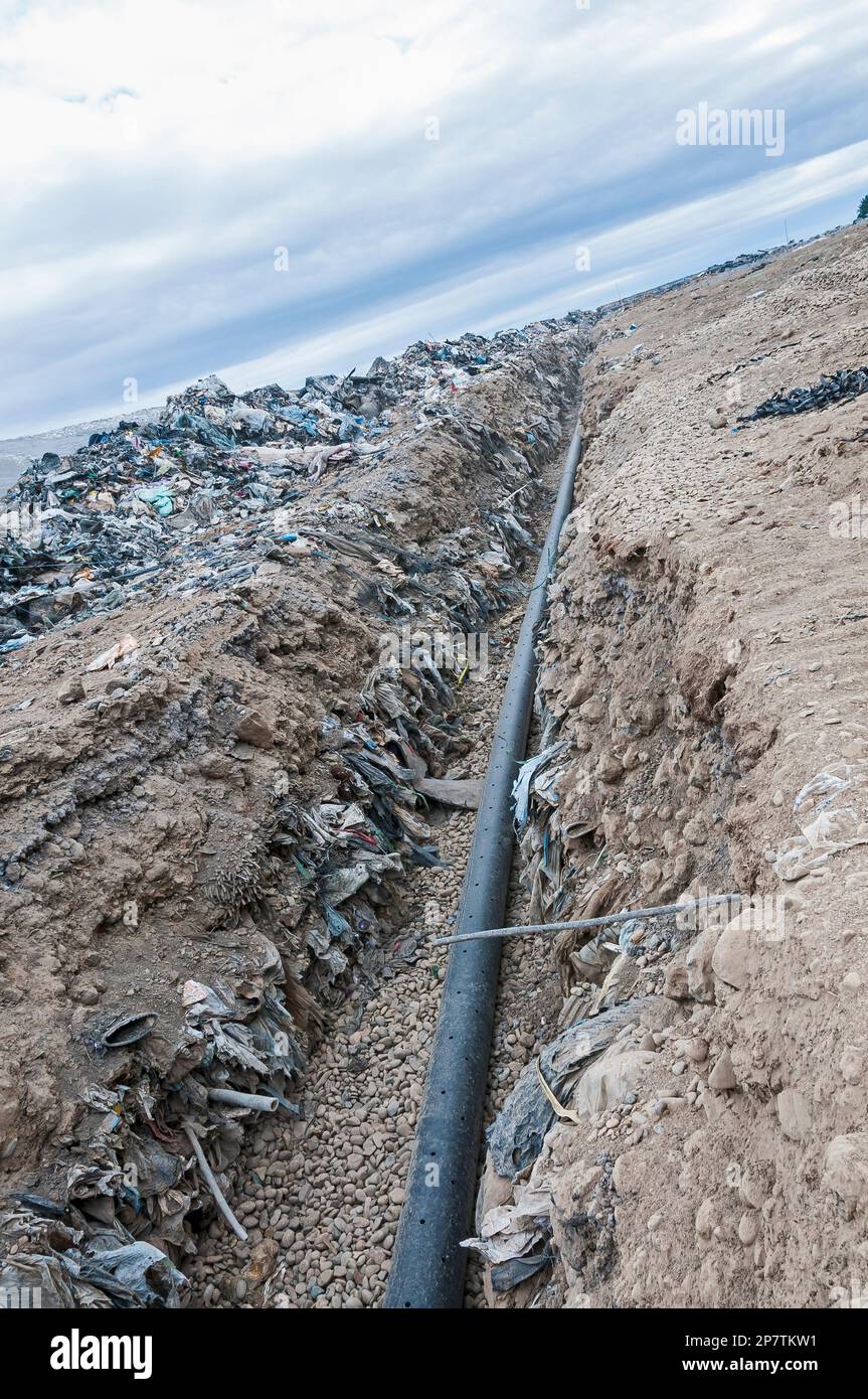A perforated pipe for methane gas is laid in a trench to be buried in