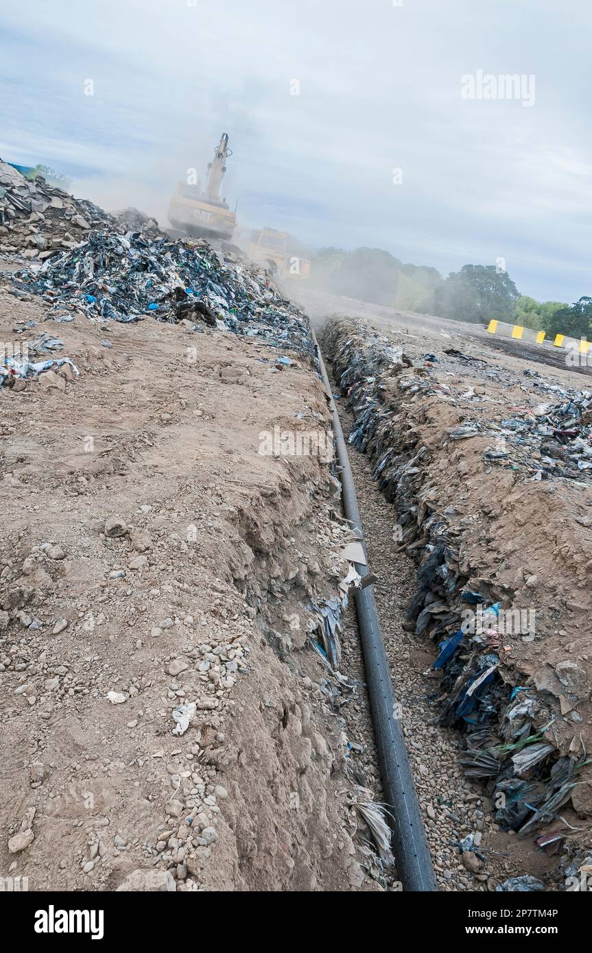 A perforated pipe for methane gas is laid in a trench to be buried in