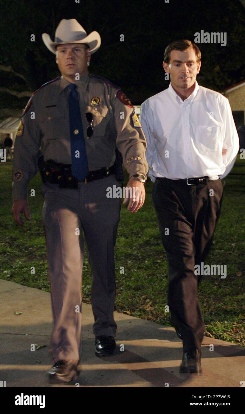 Raymond Jessop, right, is escorted to the Schleicher County jail by Sgt