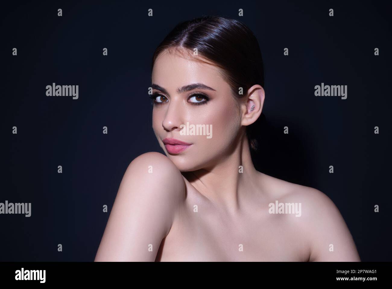 Beautiful woman with clean fresh skin on studio background. Face care ...