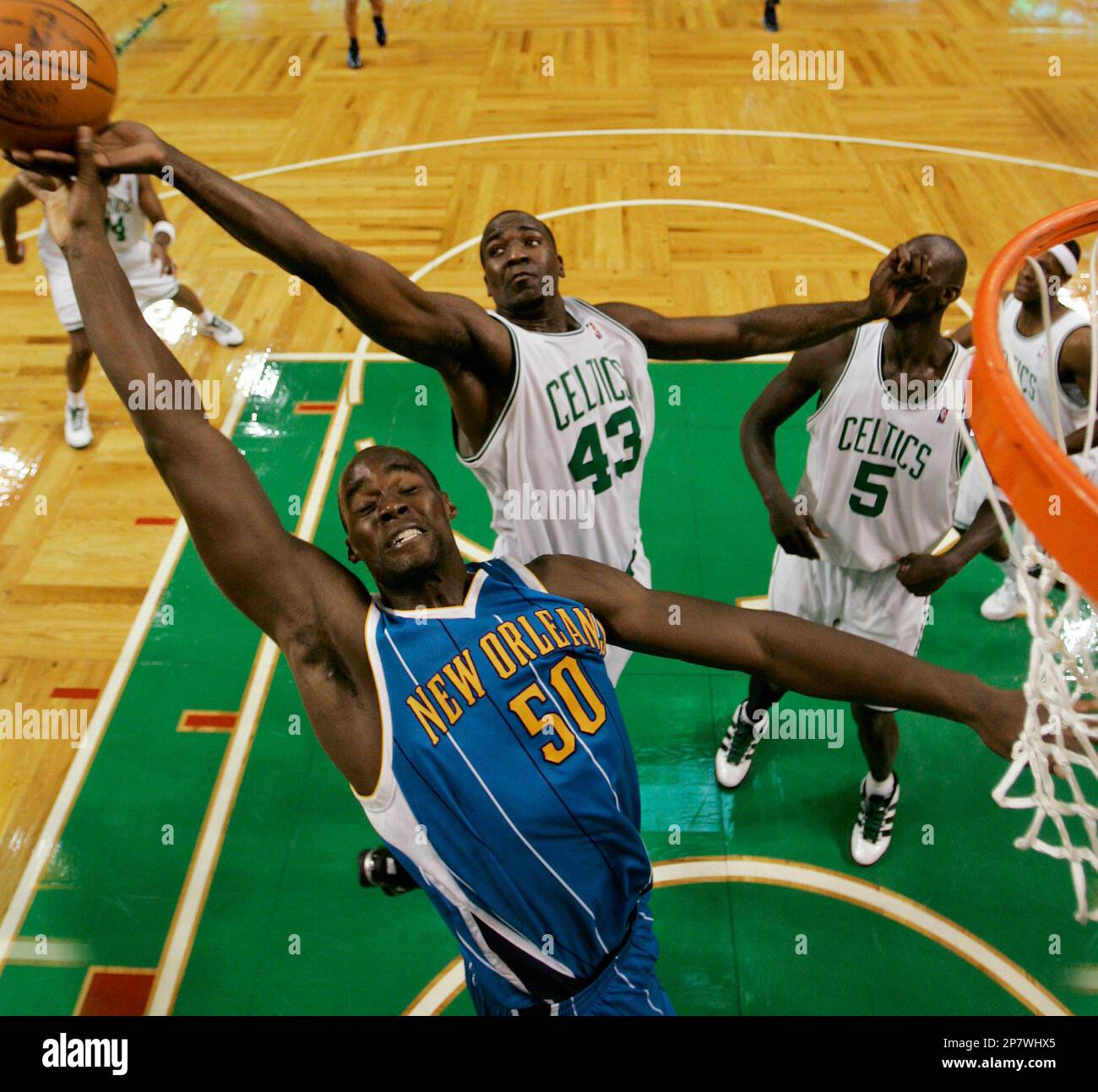 New Orleans Hornets center Emeka Okafor (50) and Boston Celtics center Kendrick Perkins (43) battle for a rebound during the second half of Boston's 97-87 win in a NBA basketball game in Boston Sunday, Nov. 1, 2009. (AP Photo/Winslow Townson) Stock Photo