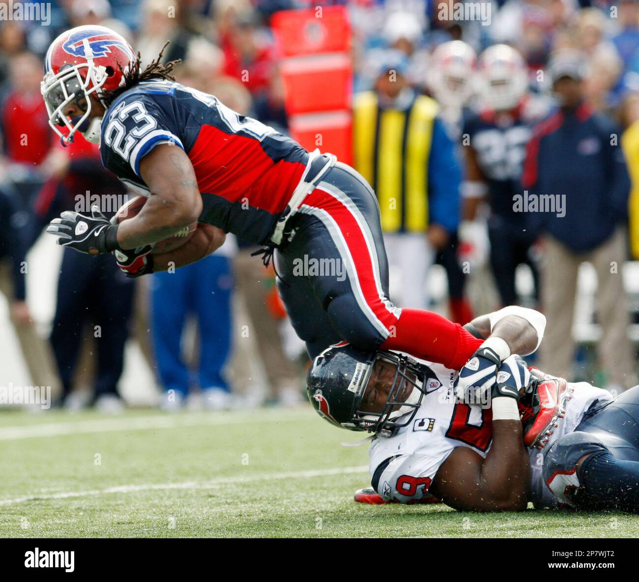 Buffalo Bills' Marshawn Lynch (23) is tackled by Houston Texans' DeMeco  Ryans (59) during the first