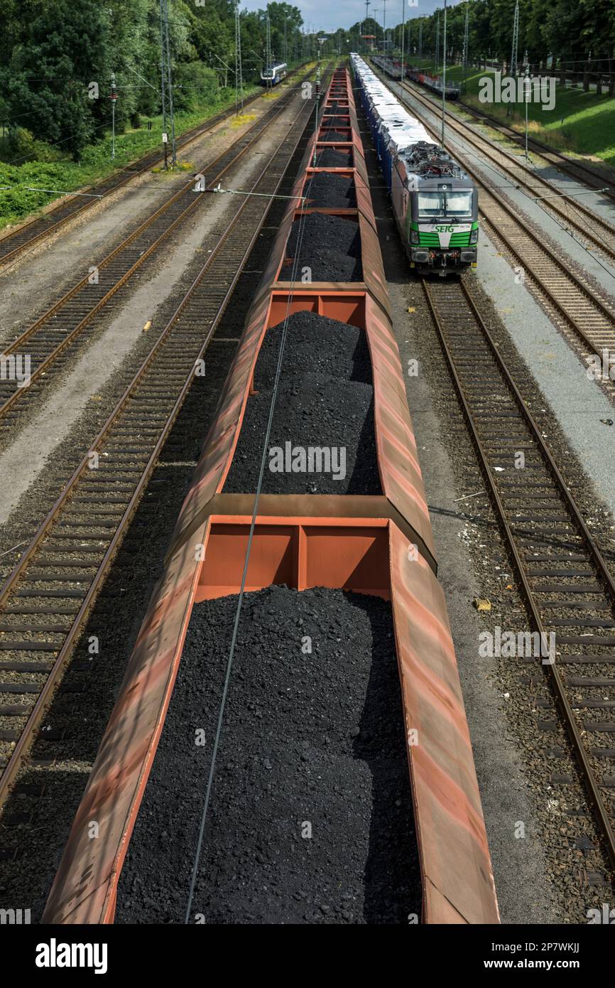 Freight wagons filled with lignite and a cargo train line up at a train station in Nordenham, Germany 2022. Stock Photo