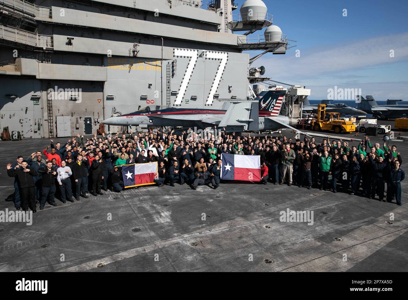 230307-N-MZ309-1068 ADRIATIC SEA (March 7, 2023) Sailors assigned to the George H.W. Bush Carrier Strike Group (CSG) and from Texas pose for a photo on the flight deck of the Nimitz-class aircraft carrier USS George H.W. Bush (CVN 77), March 7, 2023. The George H.W. Bush CSG is on a scheduled deployment in the U.S. Naval Forces Europe area of operations, employed by U.S. Sixth Fleet to defend U.S., allied, and partner interests. (U.S. Navy photo by Mass Communication Specialist 1st Class Ryan Riley) Stock Photo