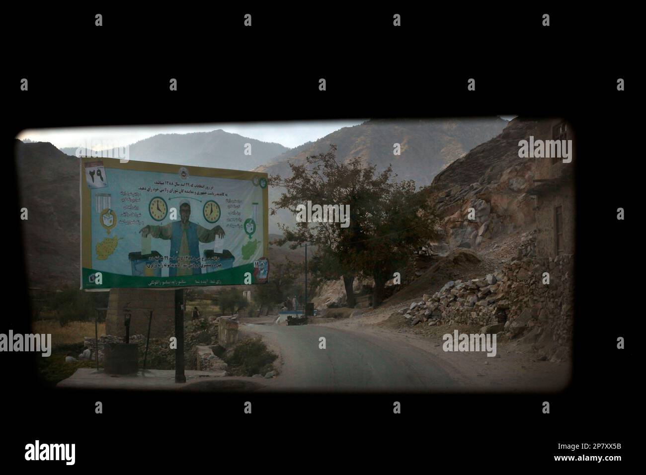 An election billboard, seen from the rear window of a patrolling U.S. army  vehicle, is seen along a rural road in the Pech Valley of Afghanistan's  Kunar province, Thursday, Oct. 22, 2009.