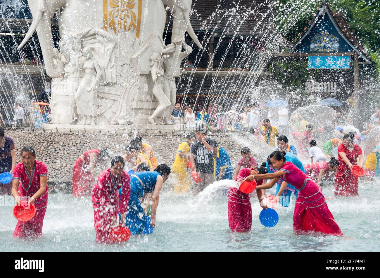 Members of the Dai minority ethnic group celebrate the new years purifying tradition of splashing water on each other at a water park in Yunnan China Stock Photo