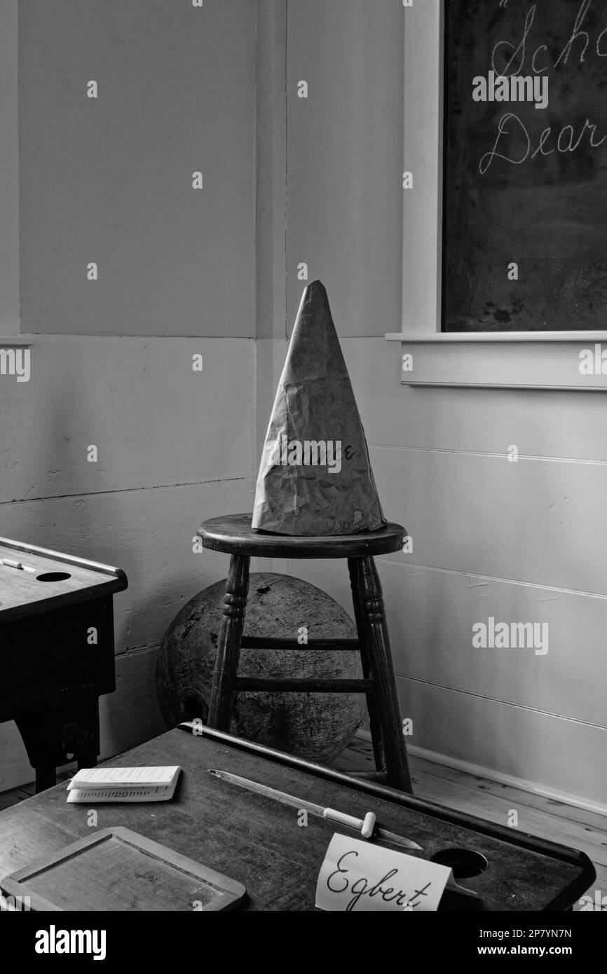 A dunce hat sits on a stool in the corner of a locally salvaged 1750