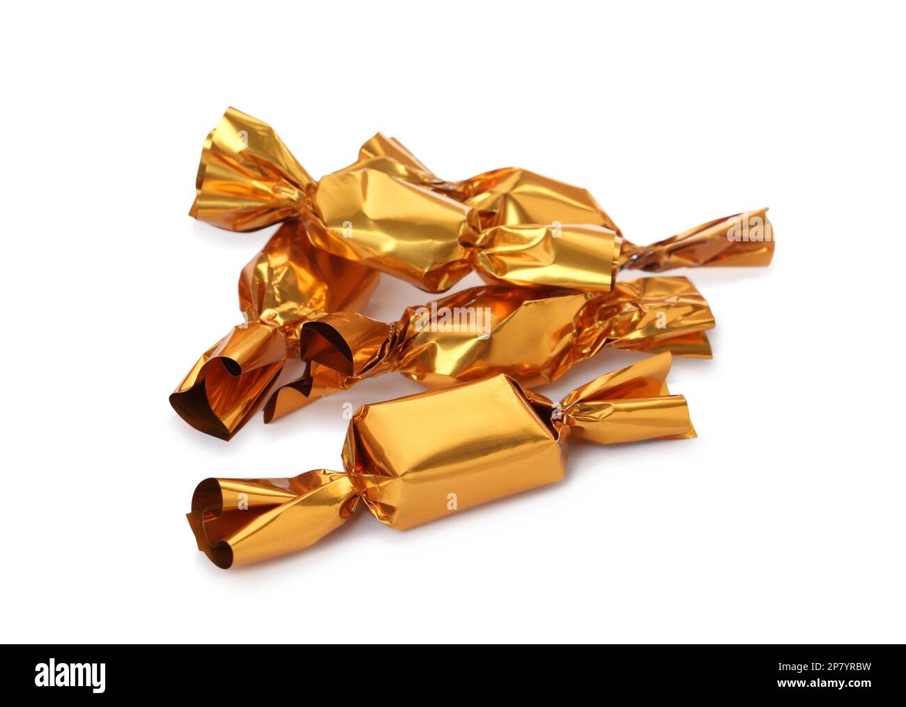 Delicious candies in golden wrappers on white background Stock Photo