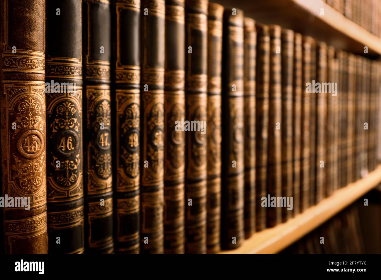 Collection of old books on shelf in library, closeup Stock Photo - Alamy
