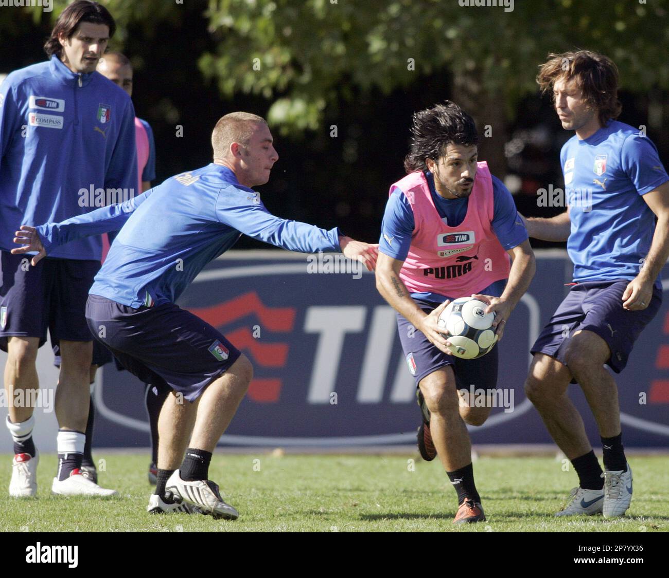 From left in background, Italy national soccer team's Vincenzo Iaquinta,  Daniele De Rossi, Gennaro Gattuso with the ball, and Andrea Pirlo, perform  a drill, during a practice session at the Coverciano training
