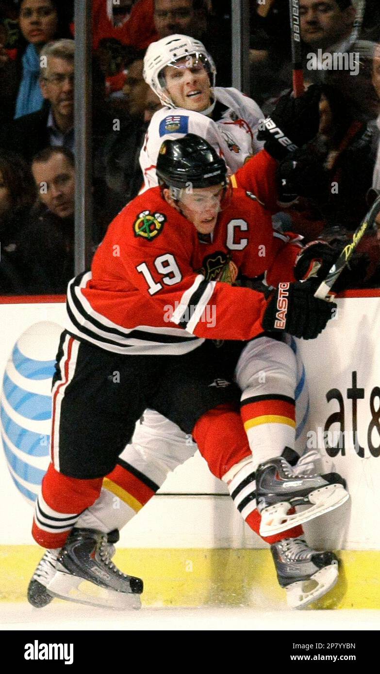 Chicago Blackhawks center Jonathan Toews checks Calgary Flames right