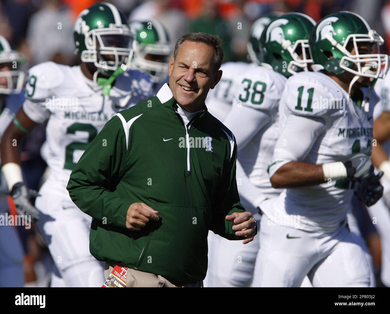 Michigan State coach Mark Dantonio runs onto the field at the beginning