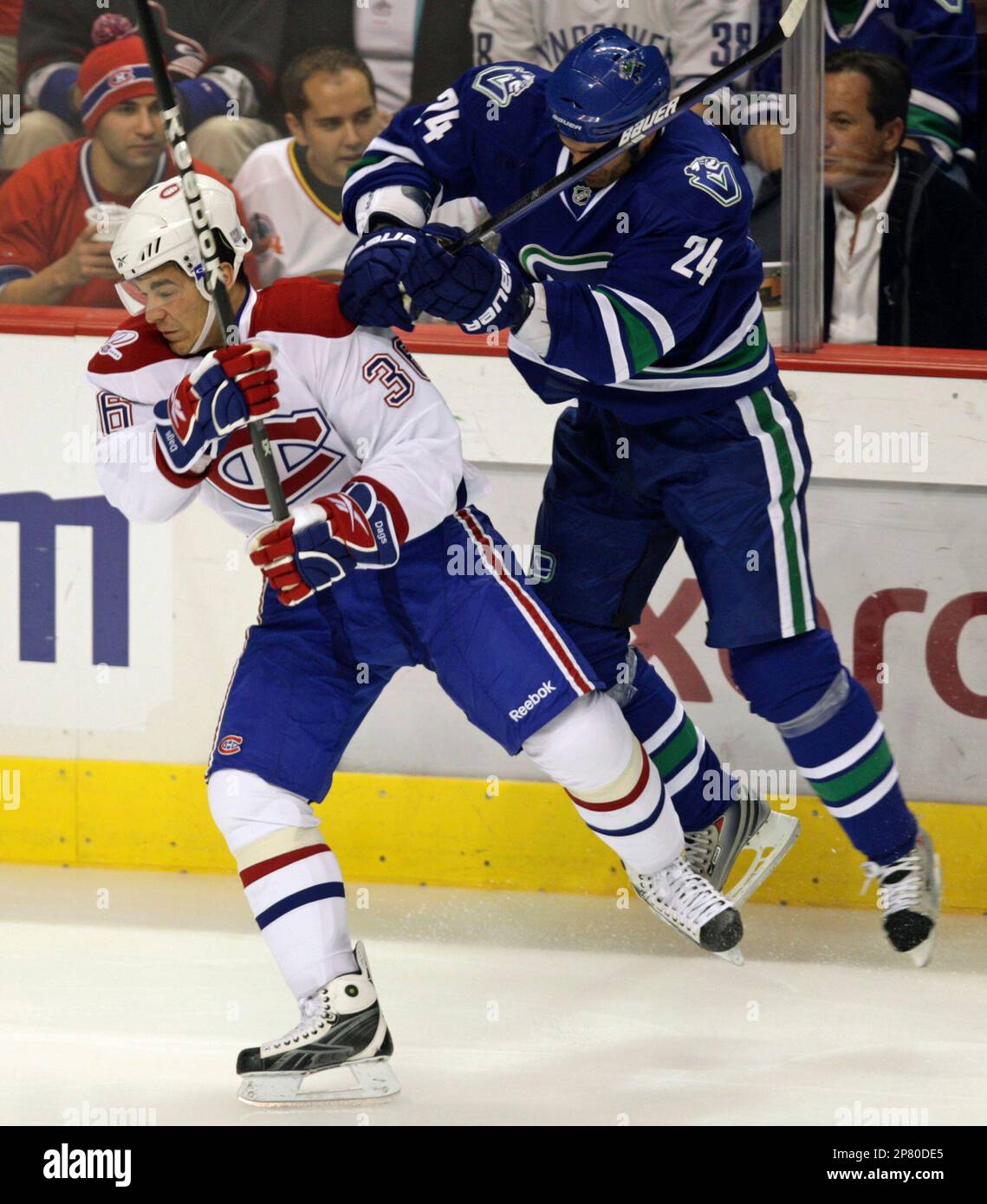 Vancouver Canucks' Darcy Hordichuk, right, checks Montreal Canadiens' Matt D'Agostini during the first period of an NHL hockey game in Vancouver, British Columbia, on Wednesday, Oct. 7, 2009. (AP Photo/The Canadian Press, Darryl Dyck) Stock Photo