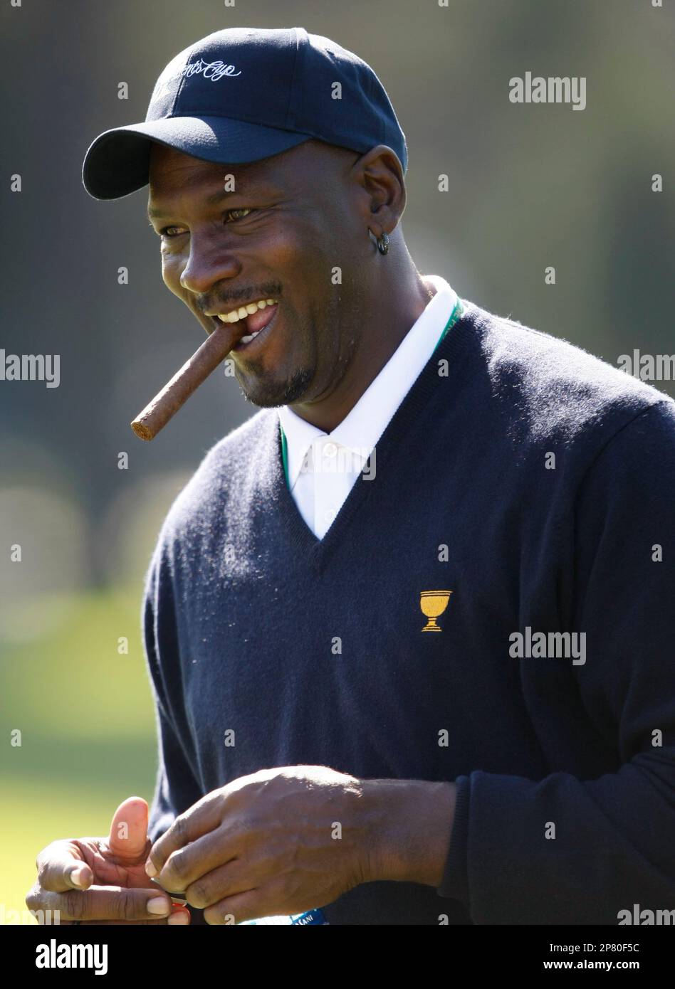FILE -- This is an Oct. 6, 2009, file photo showing United States Team  captain's assistant Michael Jordan chewing a cigar as he walks the course  during a practice round for the
