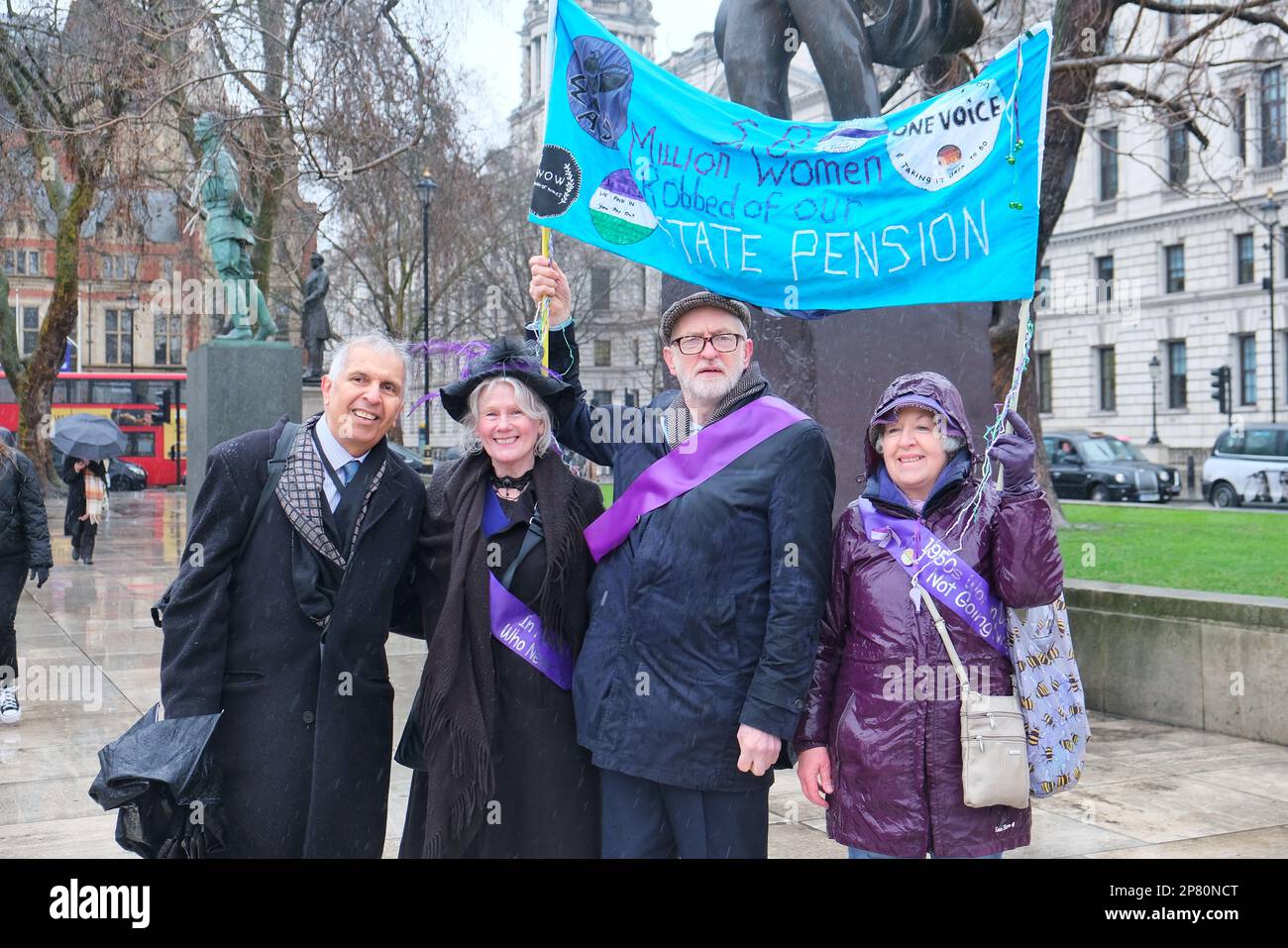 London, UK. 8th March, 2023. Labour peer, Lord Prem Sikka (L) and MP Jeremy Corbyn, second from right, join hundreds of women born in the 1950s. They gathered for a protest, part of the WASPI campaign (Women Against State Pension Inequality) after the state pension age for retirement was increased from 60 to 66 in 1995, without adequate notice in order to make the necessary finanacial arrangements. The campaign group's next step is to crowdfund a judicial review over the errors made by a Parliamentary watchdog. Credit: Eleventh Hour Photography/Alamy Live News Stock Photo