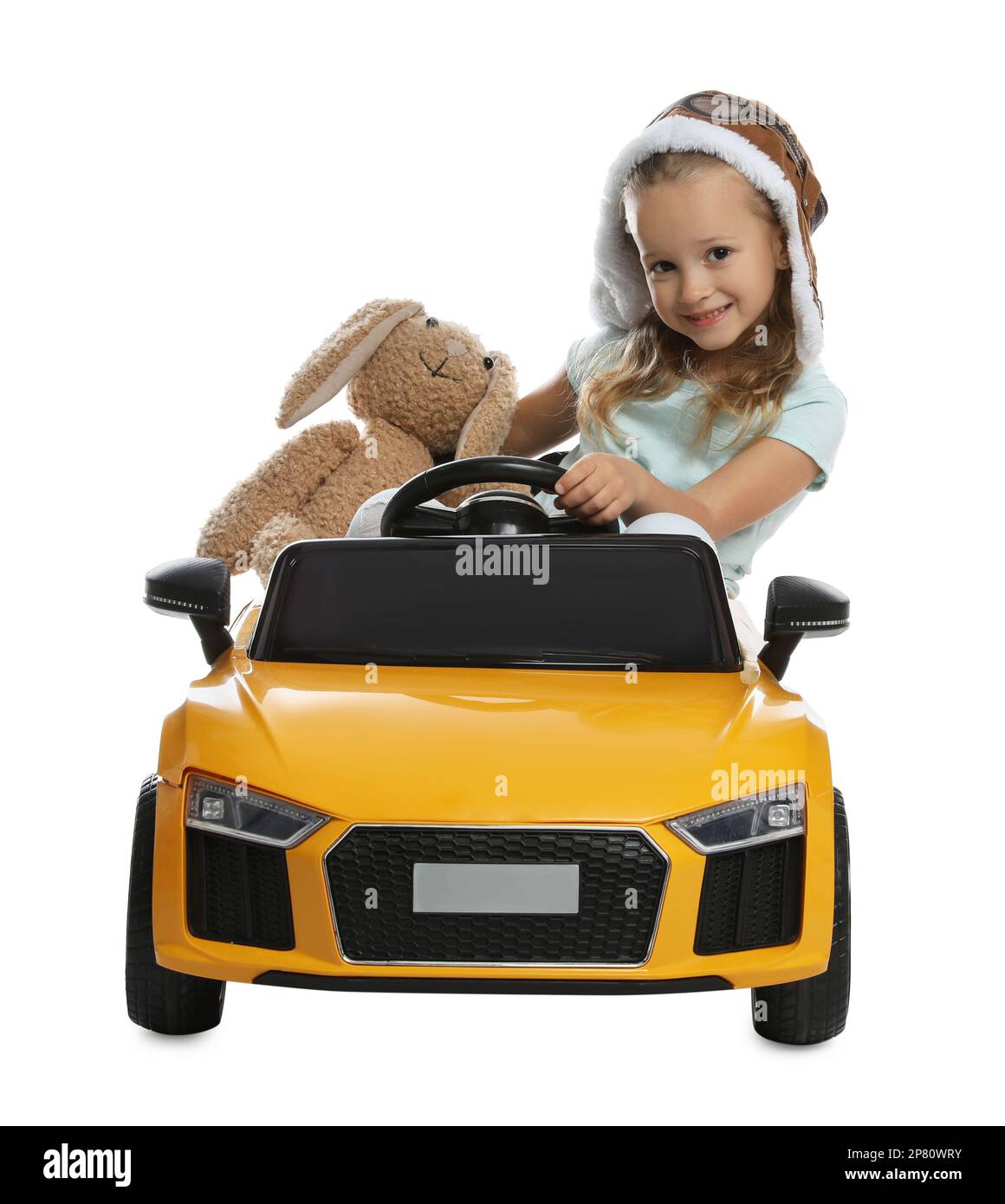 Cute little girl with toy bunny driving children's car on white background Stock Photo Alamy