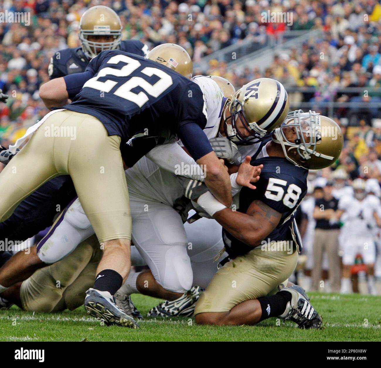 Washington quarterback Jake Locker, center, scores a first quarter