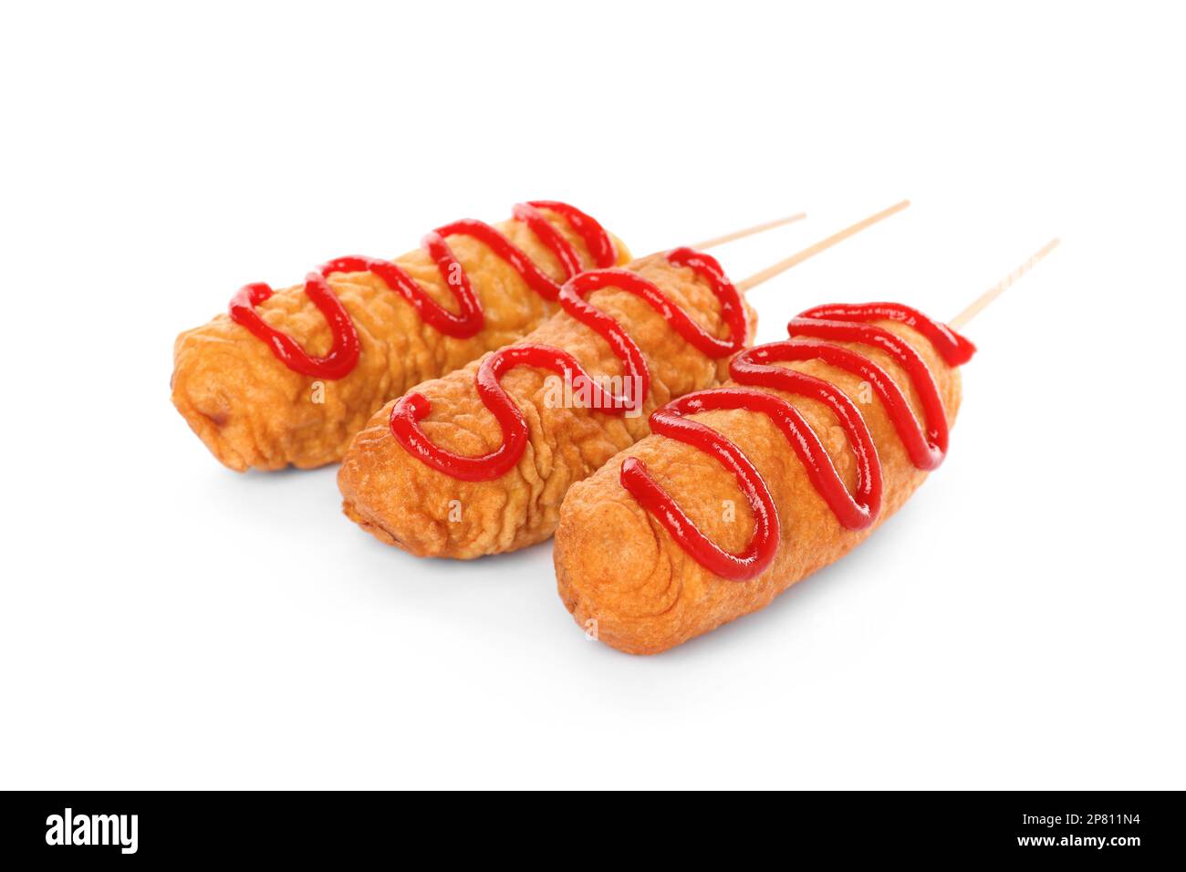 Delicious deep fried corn dogs with ketchup on white background Stock