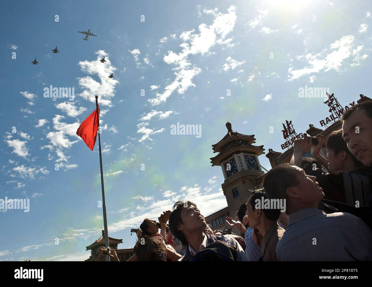 Peoples watch Chinese People's Liberation Army air force jets fly in ...