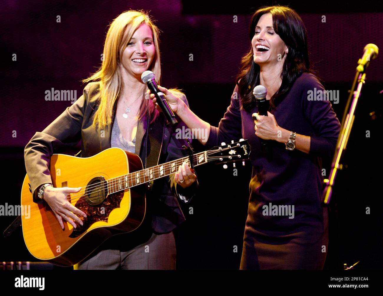 Lisa Kudrow, left, performs "Smelly Cat" as Courteney Cox laughs during