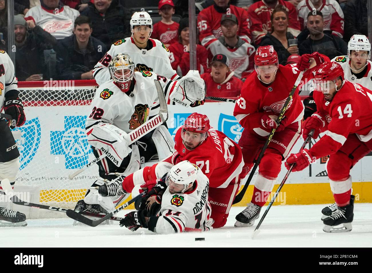 Chicago Blackhawks center Jason Dickinson (17) and Detroit Red Wings center Dylan Larkin (71) hit the ice as they watch the puck in the first period of an NHL hockey game Wednesday,