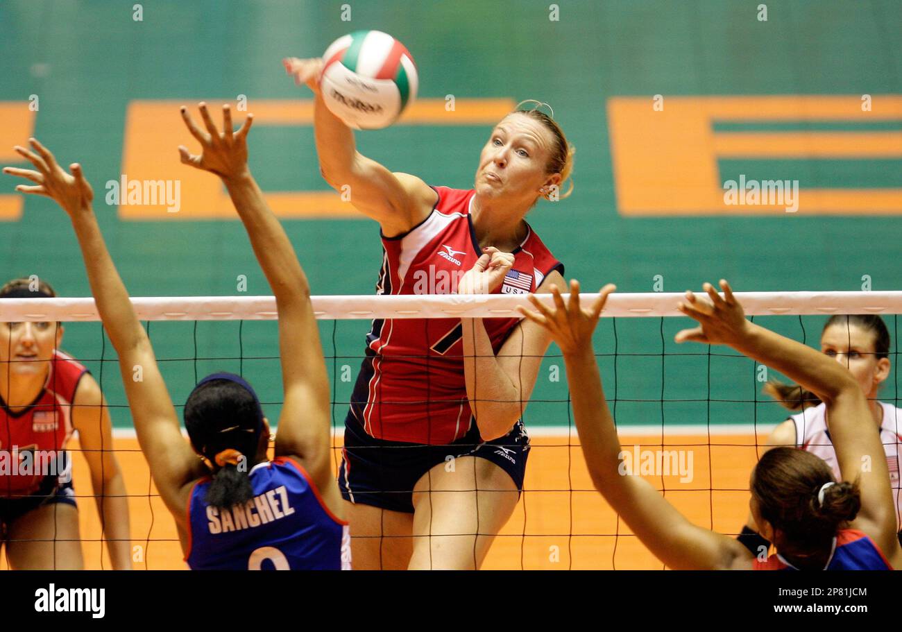 US Heather Bown, center, spikes the ball past Cubas Rachel Sanchez, left, and Yusidey Silie during their match for the third place at the XXI NORCECA Volleyball Championship in Bayamon, Puerto Rico,