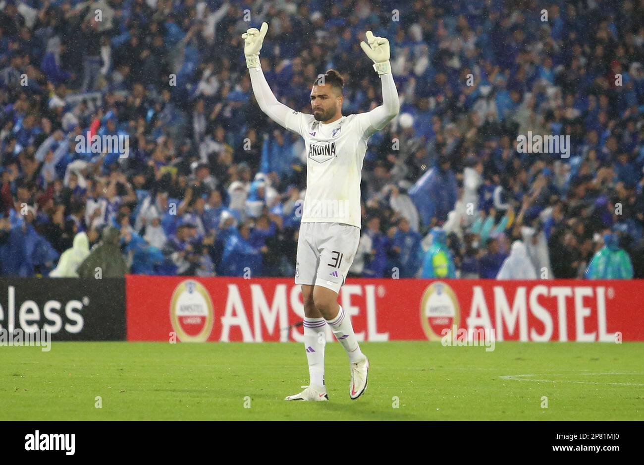 David Silva of Colombia's Millonarios, left, heads to score his side's  opening goal against Brazil's Atletico Mineiro during a Copa Libertadores  soccer match at El Campin stadium in Bogota, Colombia, Wednesday, March