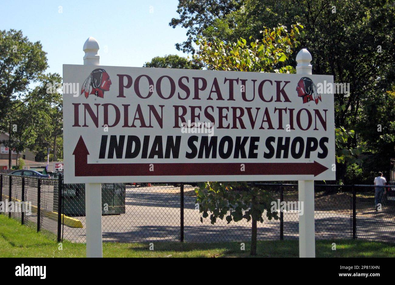 A sign at the entrance of the Poospatuck Indian reservation in Mastic, N.Y.,  is seen Friday, Sept. 25, 2009, pointing in the direction of smoke shops.  An order took effect Friday barring