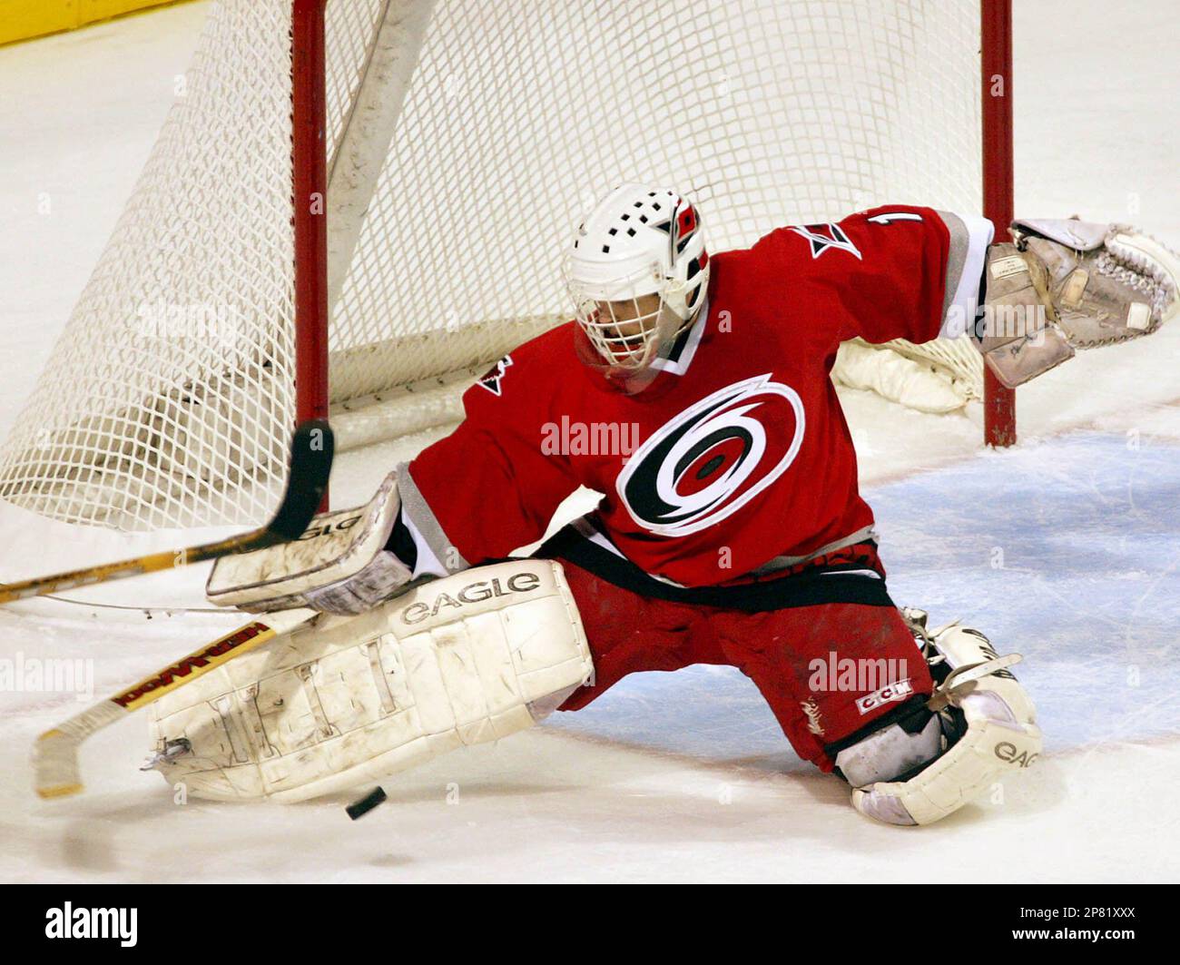 ** ADVANCE FOR WEEKEND EDITIONS, SEPT. 26-27 ** FILE - In this Nov. 23, 2002, file photo, Carolina Hurricanes' goalie Arturs Irbe makes a save against the Montreal Canadiens during first period NHL action in Montreal. Long before everyone started calling him Archie, Arturs Irbe came to North America with only a few words of English in his vocabulary. Now that he's retired after a successful career as a goaltender, Irbe is back in the States, teaching the same basic words to Washington Capitals up-and-comer Semyon Varlamov.(AP Photo/The Canadian Press, Andre Forget, File) Stock Photo