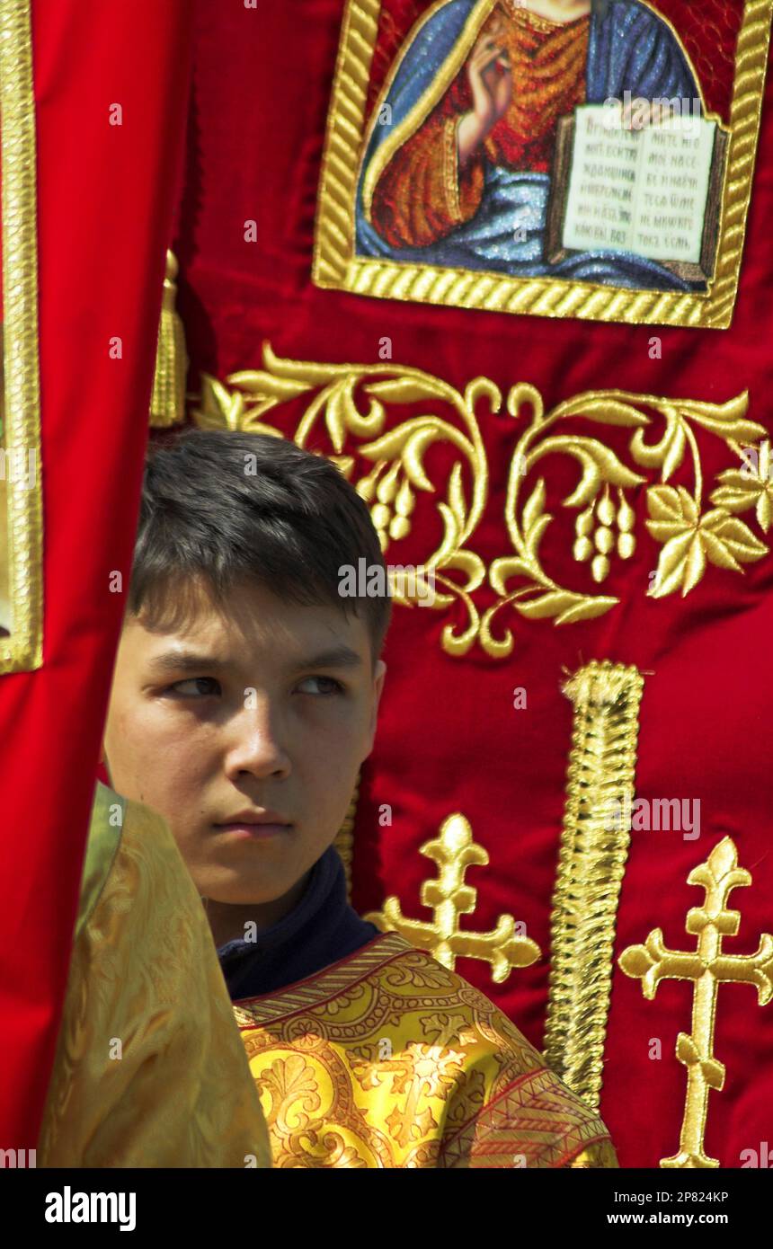 Boy acolyte participates at a Russian Orthodox Christian procession inside the Kremlin, Moscow Stock Photo
