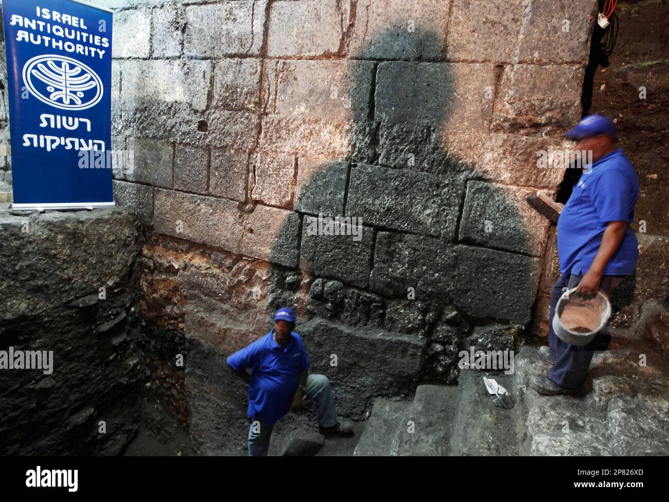Israeli workers stand on the steps of a newly discovered ancient Jewish