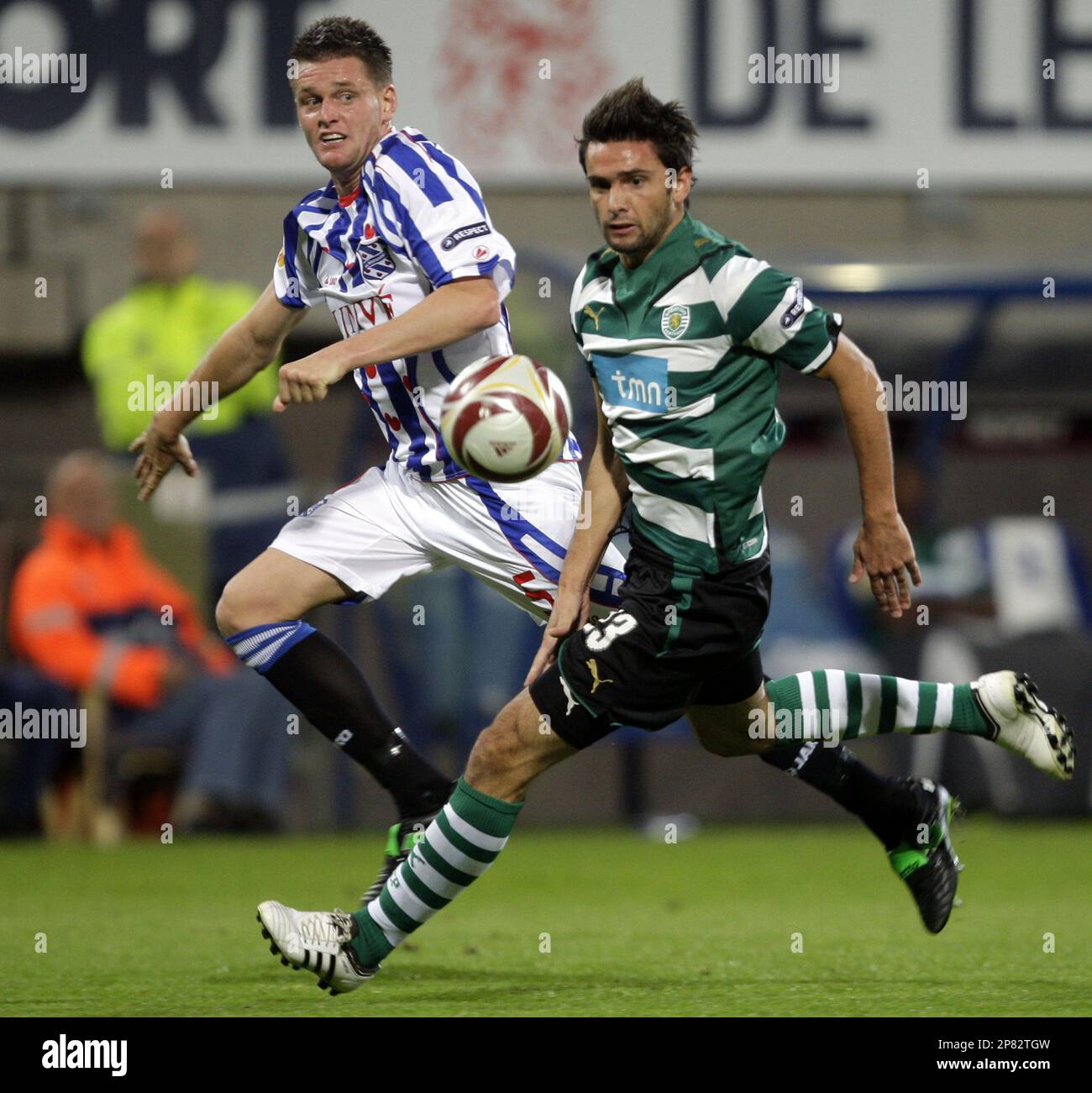 Michael Dingsdag of SC Heerenveen, left and Helder Postiga of Sporting  battle for the ball, during their Europa League first round Group D soccer  match at the Abe Lenstra stadium in Heerenveen,
