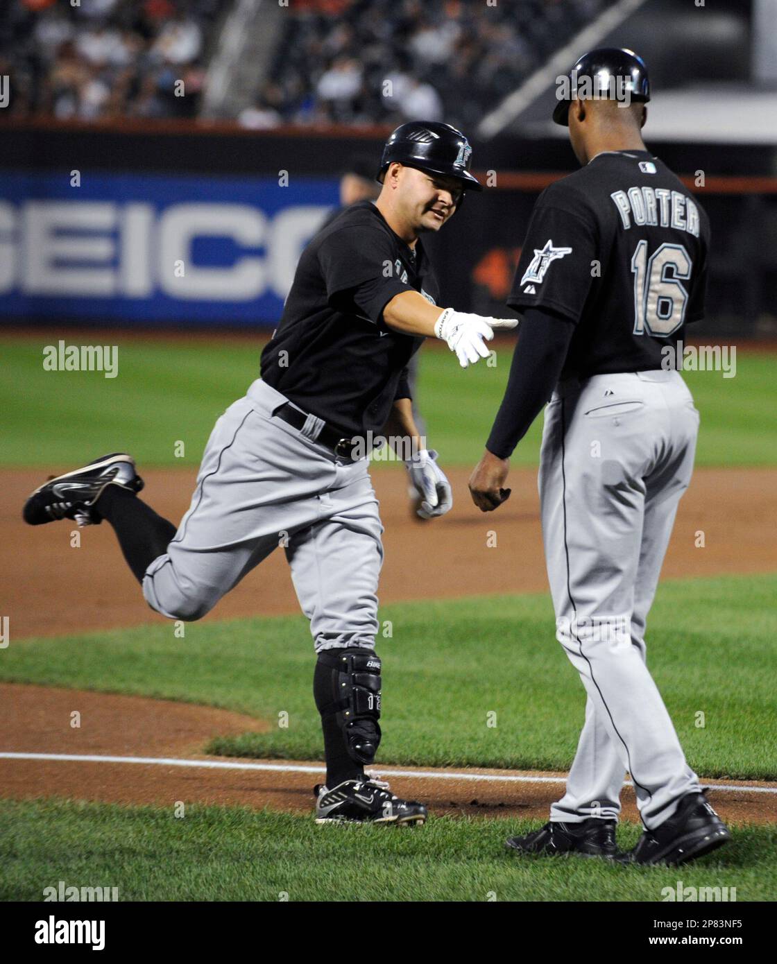 Florida Marlins' Cody Ross, left, is congratulated by third base coach ...